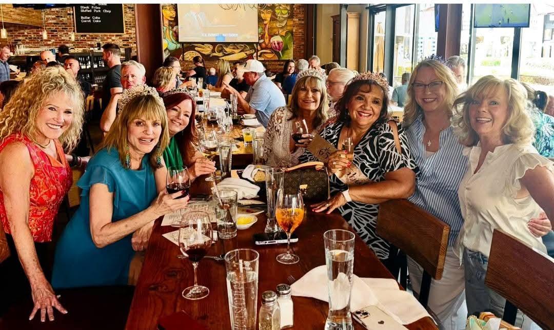 Friends gathered around a long table for a celebratory evening