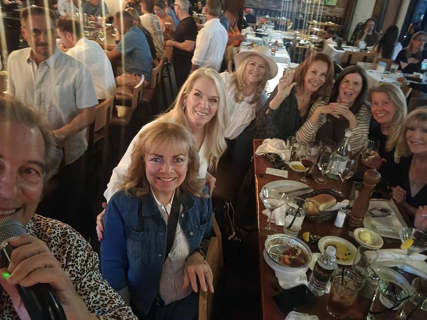 A large group of friends enjoying dinner together at the show