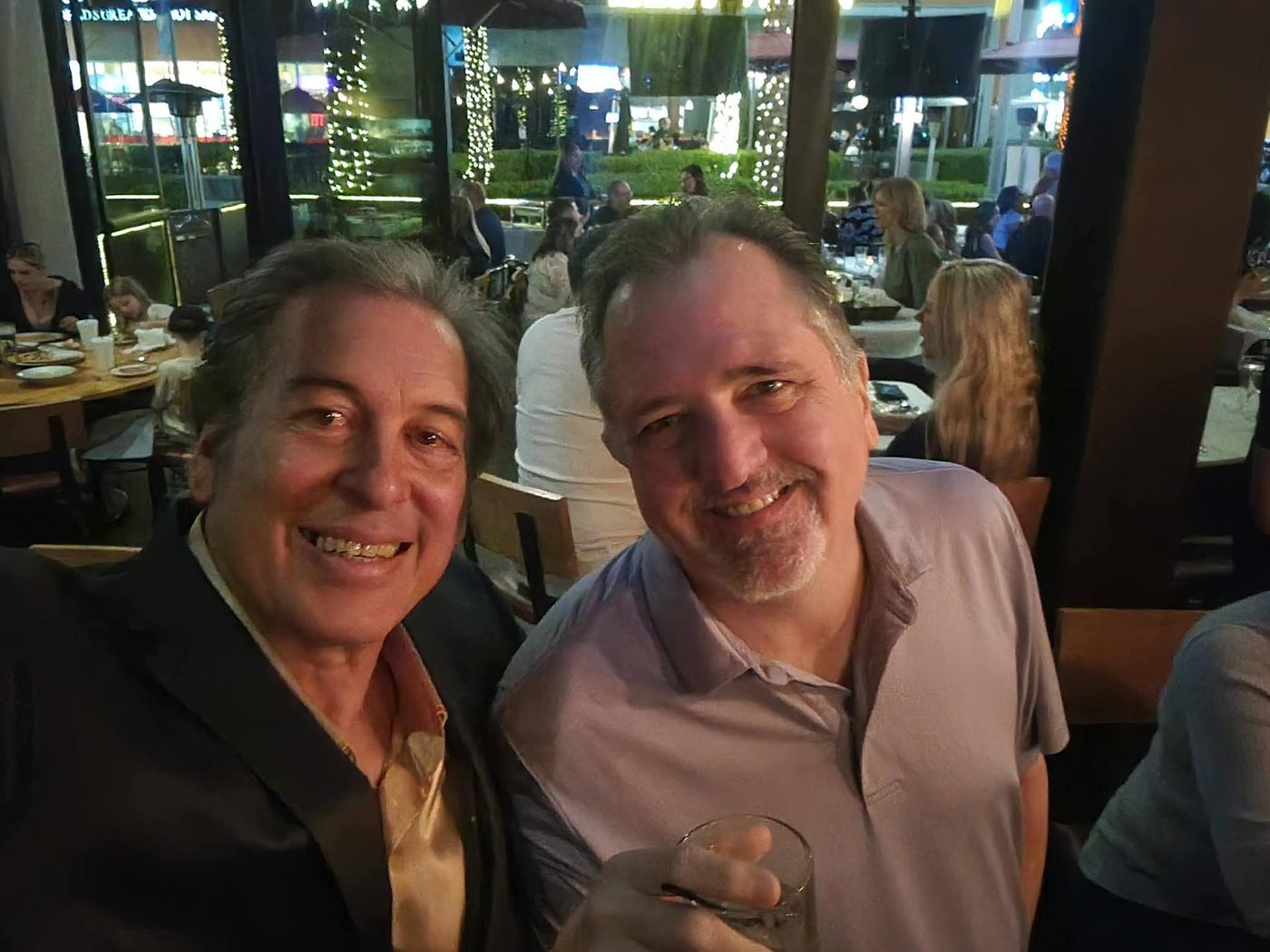 Craig sharing a relaxed moment with a friend at the venue