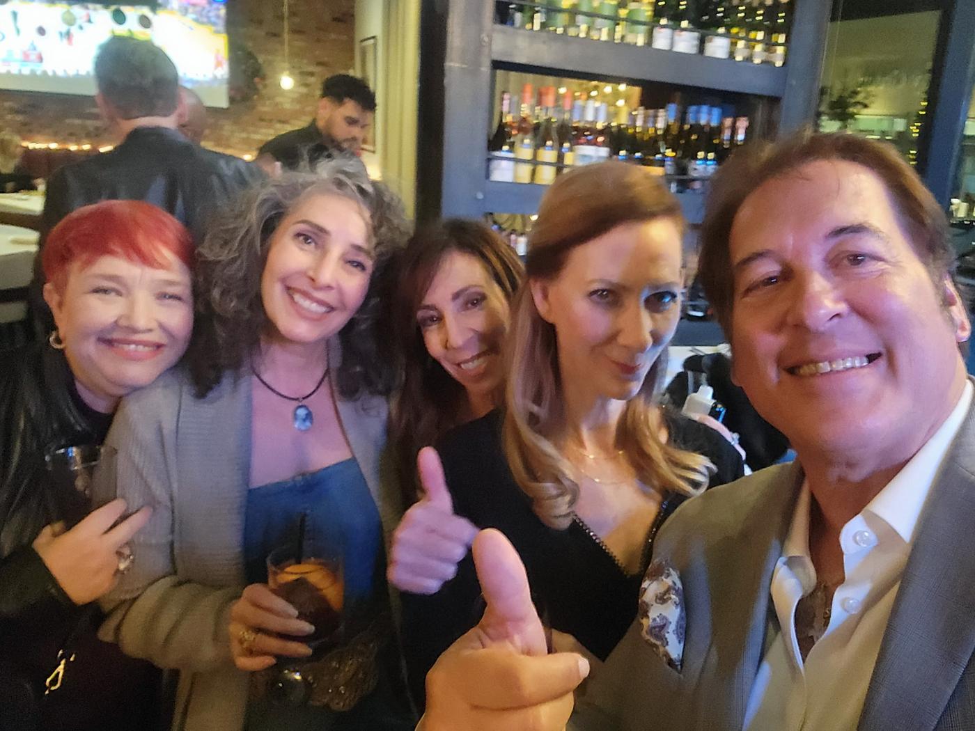 Friends and fans smiling together while enjoying a night of live music