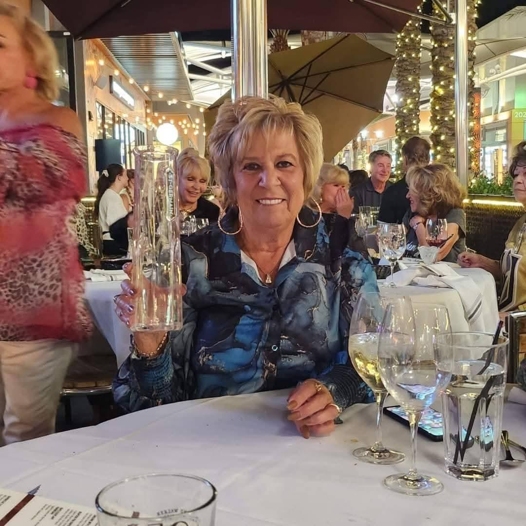 A smiling guest enjoying dinner and live entertainment